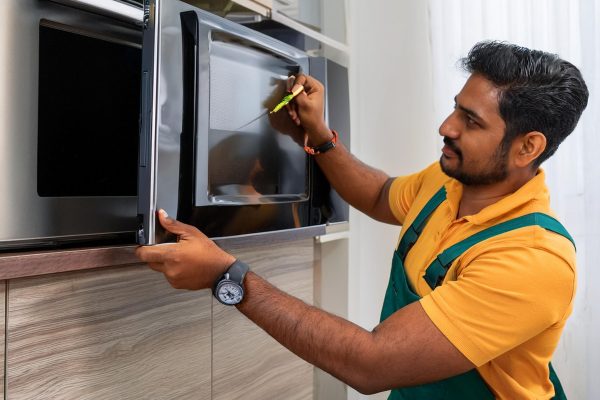 Firefly indian man installing a television, refridgerator, washing machine, kitchen hob 4923